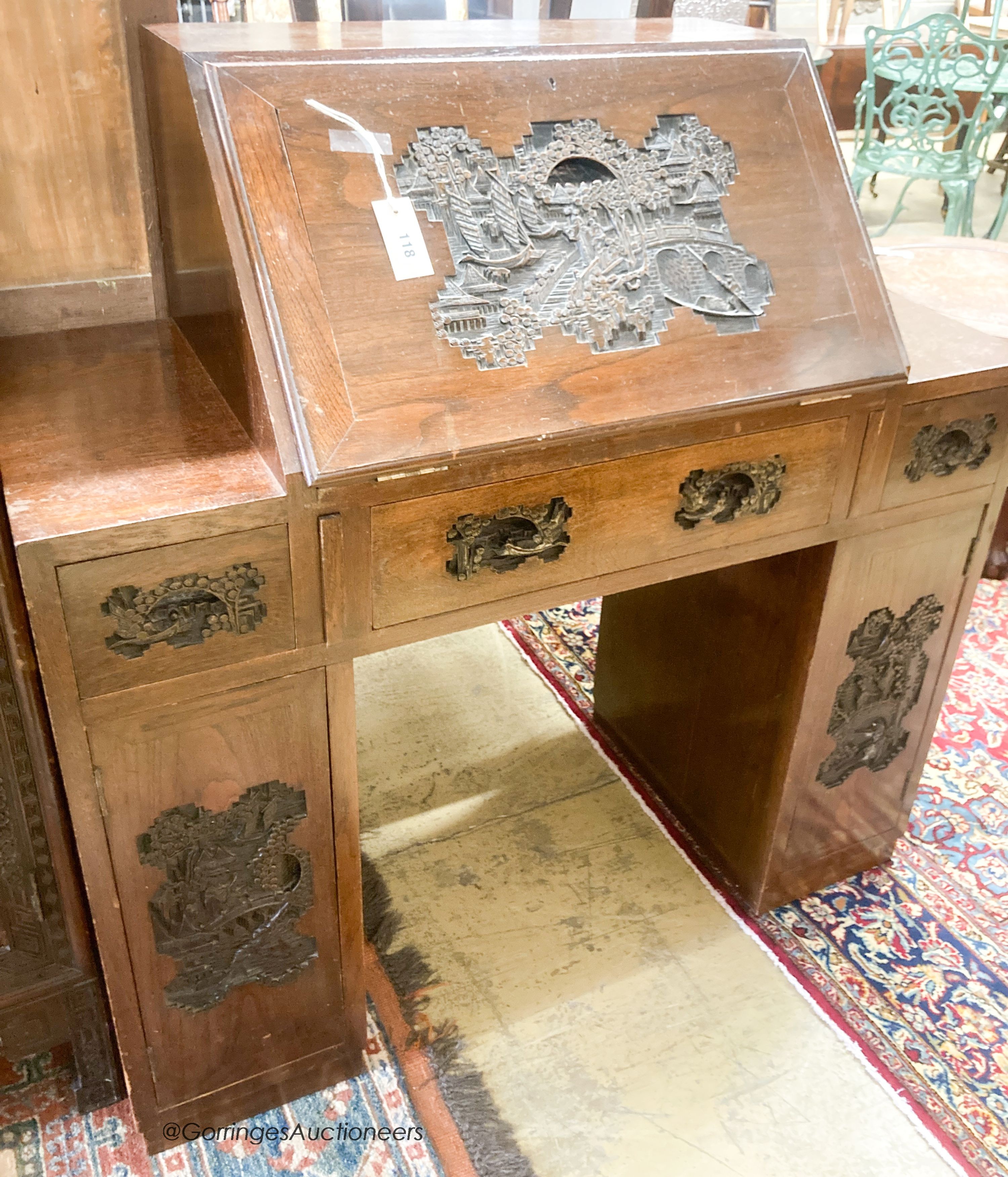 A 20th century Chinese carved hardwood bureau fitted with three drawers, width 107cm, depth 45cm, height 108cm and a cupboard